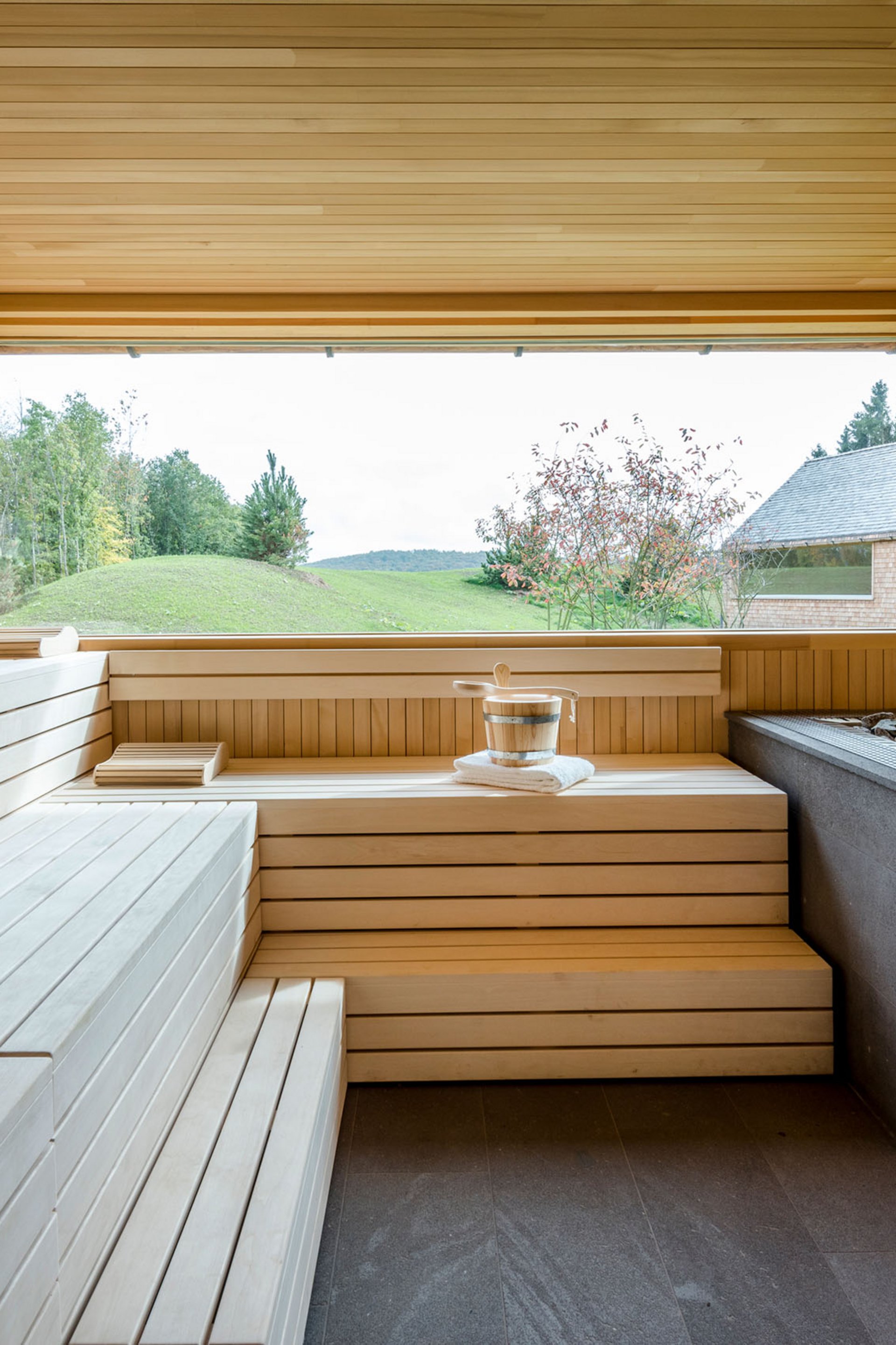 Seezeitlodge : Galerie photos Salle de sauna en bois moderne avec grande fenêtre donnant sur paysage