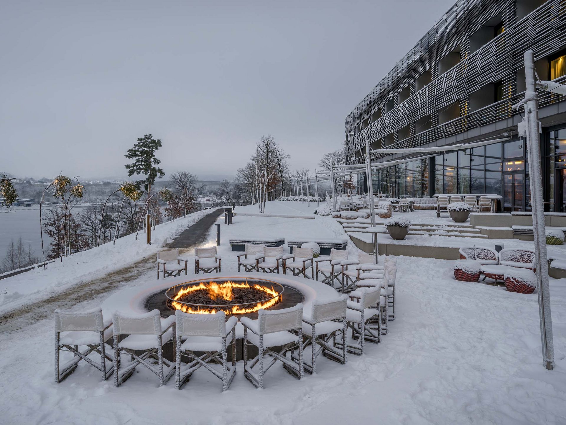 Die Seezeitlodge: Ihr Hotel am Bostalsee Verschneite Hotelterrasse mit Sitzgruppen und brennender Feuerschale