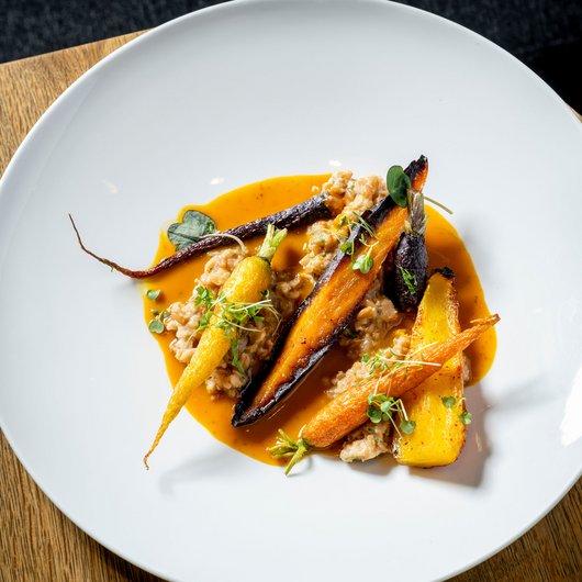 LUMI: our restaurant at Lake Bostalsee Roasted colorful carrots with sauce on a white plate