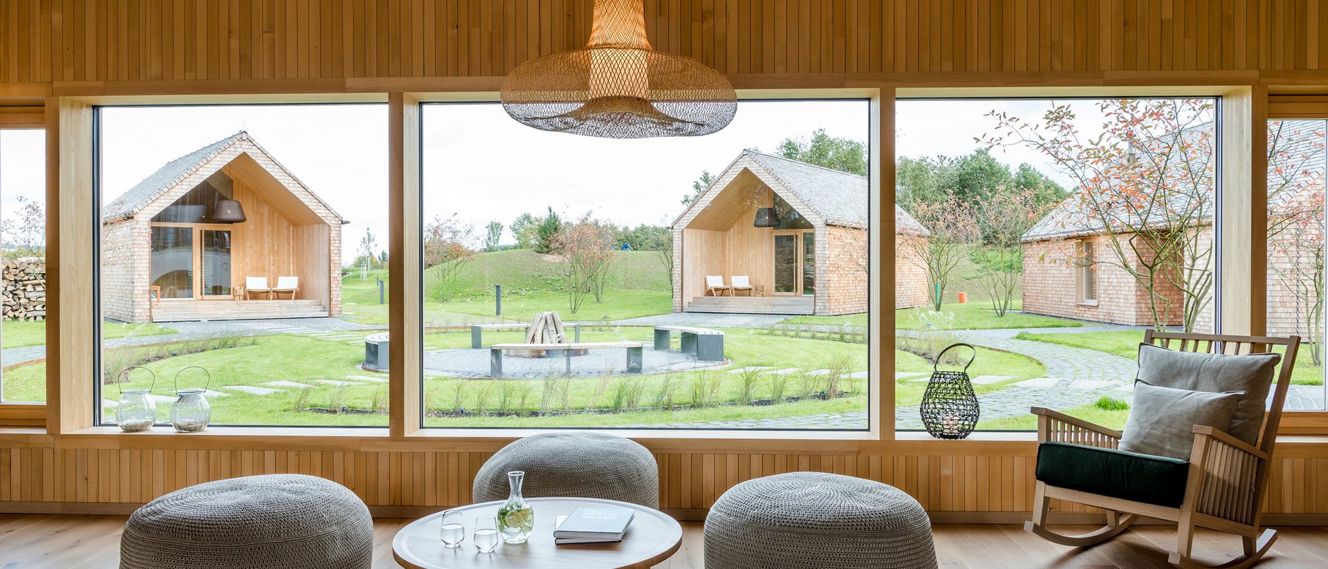 Seezeitlodge : Galerie photos Salon moderne avec grandes fenêtres donnant sur jardin et maisons