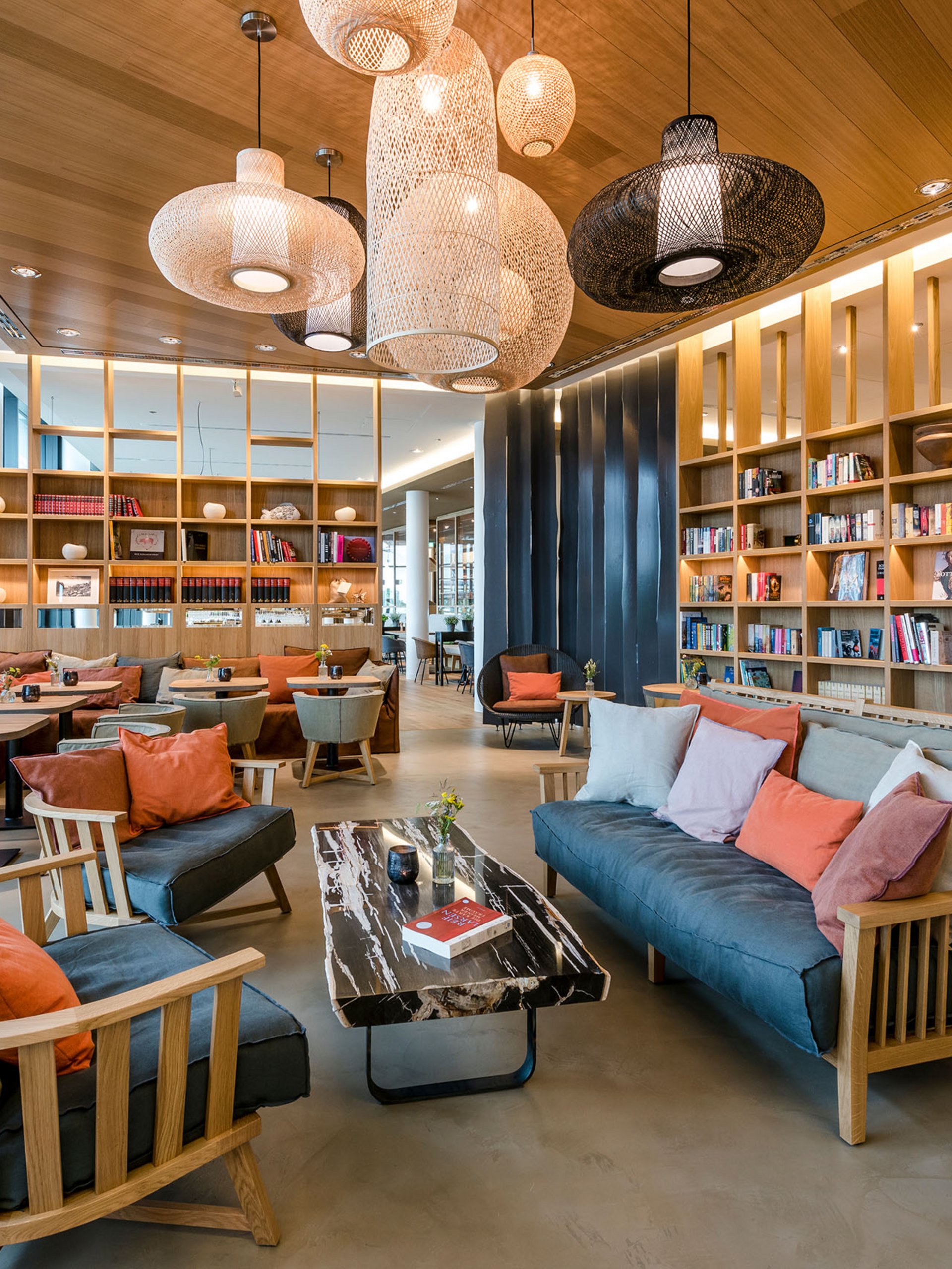 Seezeitlodge : Galerie photos Bibliothèque moderne avec canapés confortables, étagères en bois et suspensions